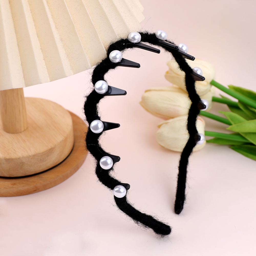 Black headband with pearls on a light pink background with tulips